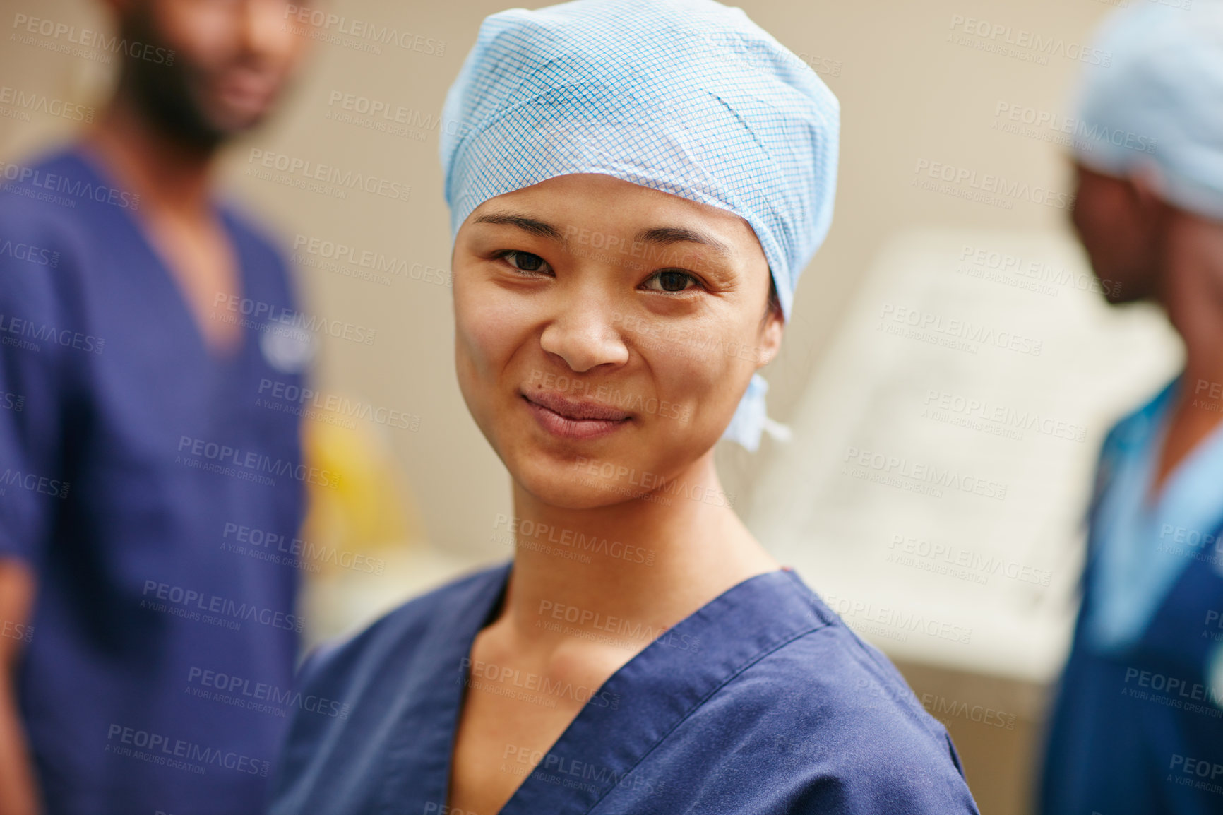 Buy stock photo Cropped portrait of a female nurse standing in a hospital with her colleagues in the background