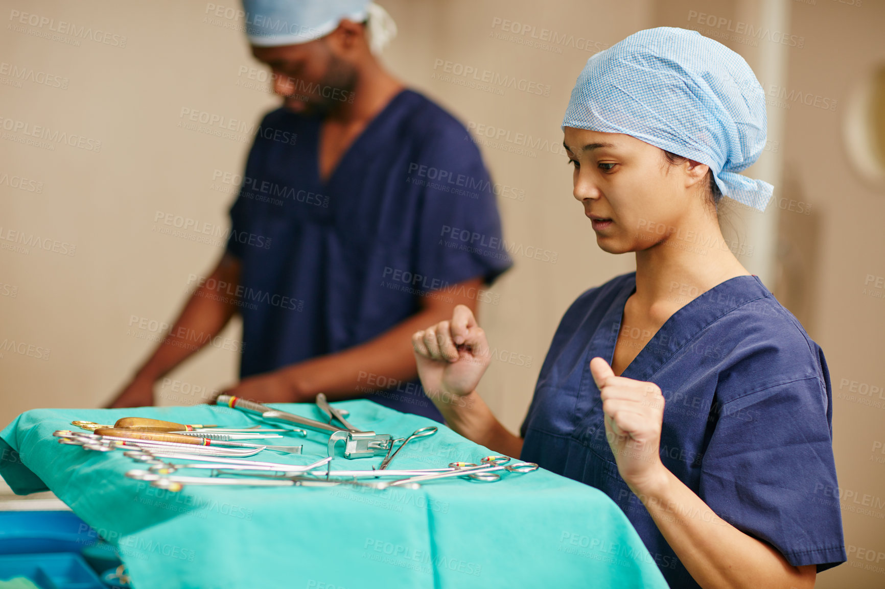 Buy stock photo Shot of a surgeon deciding which surgical instrument to use