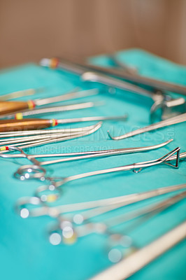 Buy stock photo Shot of a variety of surgical instruments on a table