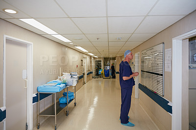 Buy stock photo Full length shot of a male doctor writing on a whiteboard in the hospital