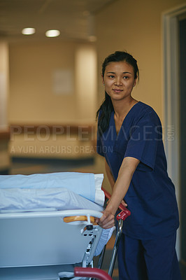 Buy stock photo Cropped shot of a female nurse standing beside a hospital bed