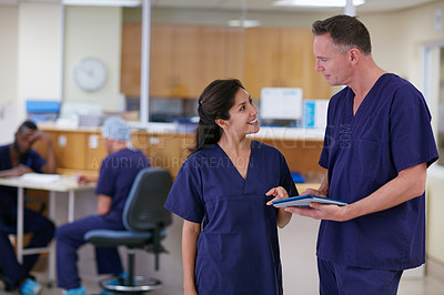 Buy stock photo Shot of two medical practitioners having a conversation in a hospital