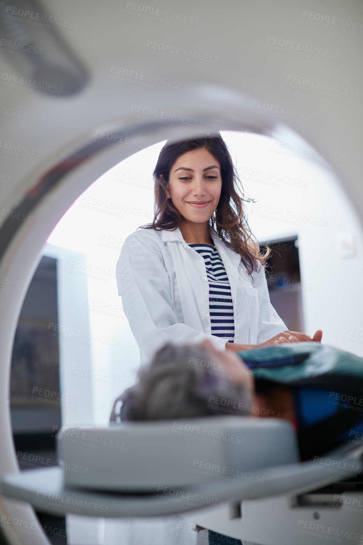 Buy stock photo Shot of a mature woman being comforted by a doctor before and MRI scan