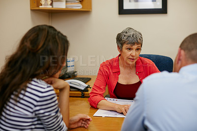 Buy stock photo Rearview shot of a couple sitting in a meeting with their financial advisor