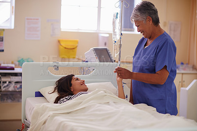 Buy stock photo Shot of a nurse talking to her patient