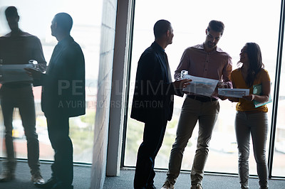 Buy stock photo Cropped shot of three businesspeople talking in the boardroom