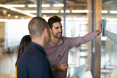 Buy stock photo Cropped shot of three businesspeople working in the office