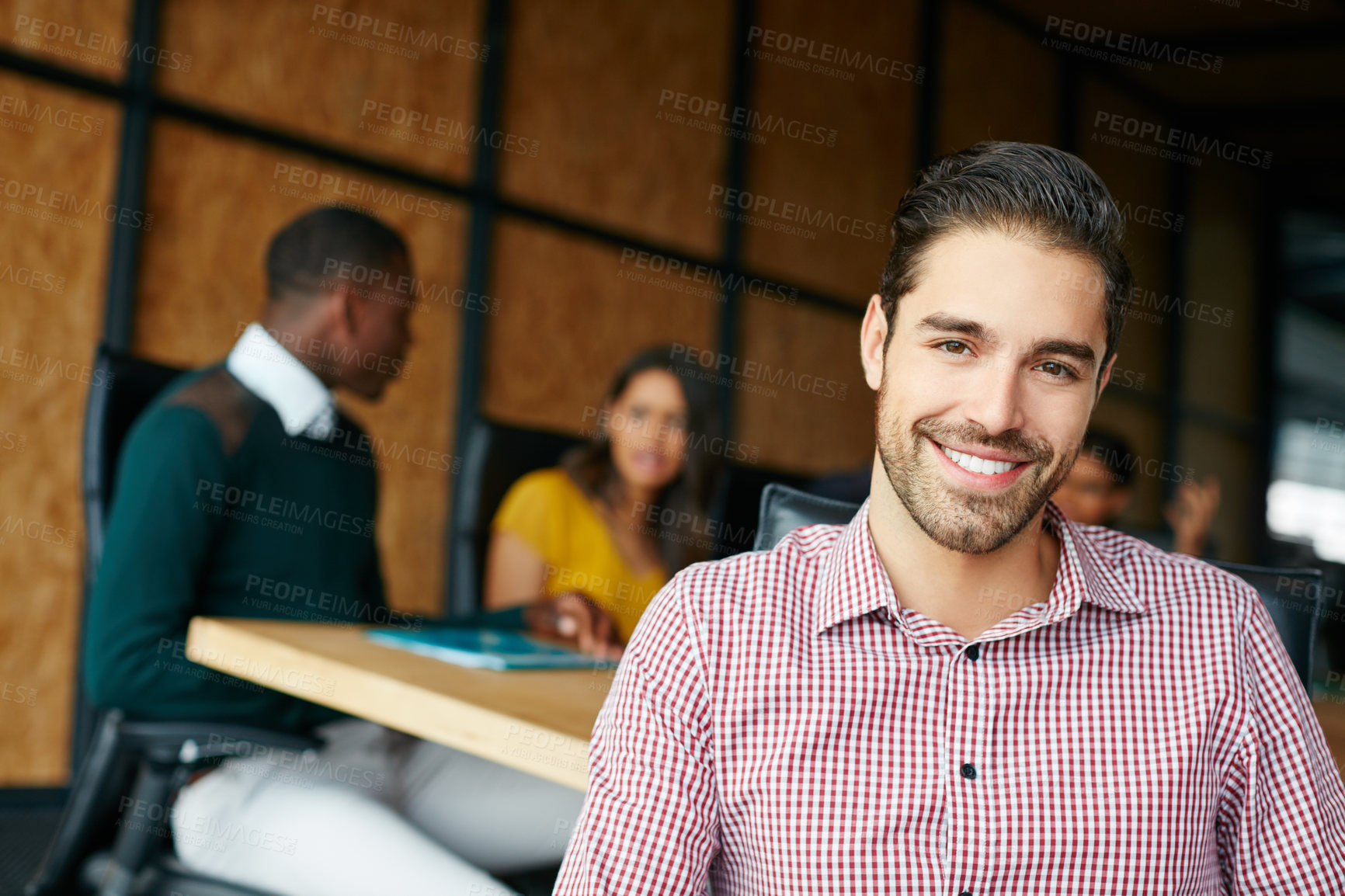 Buy stock photo Portrait of an office worker in a meeting with colleagues in the background