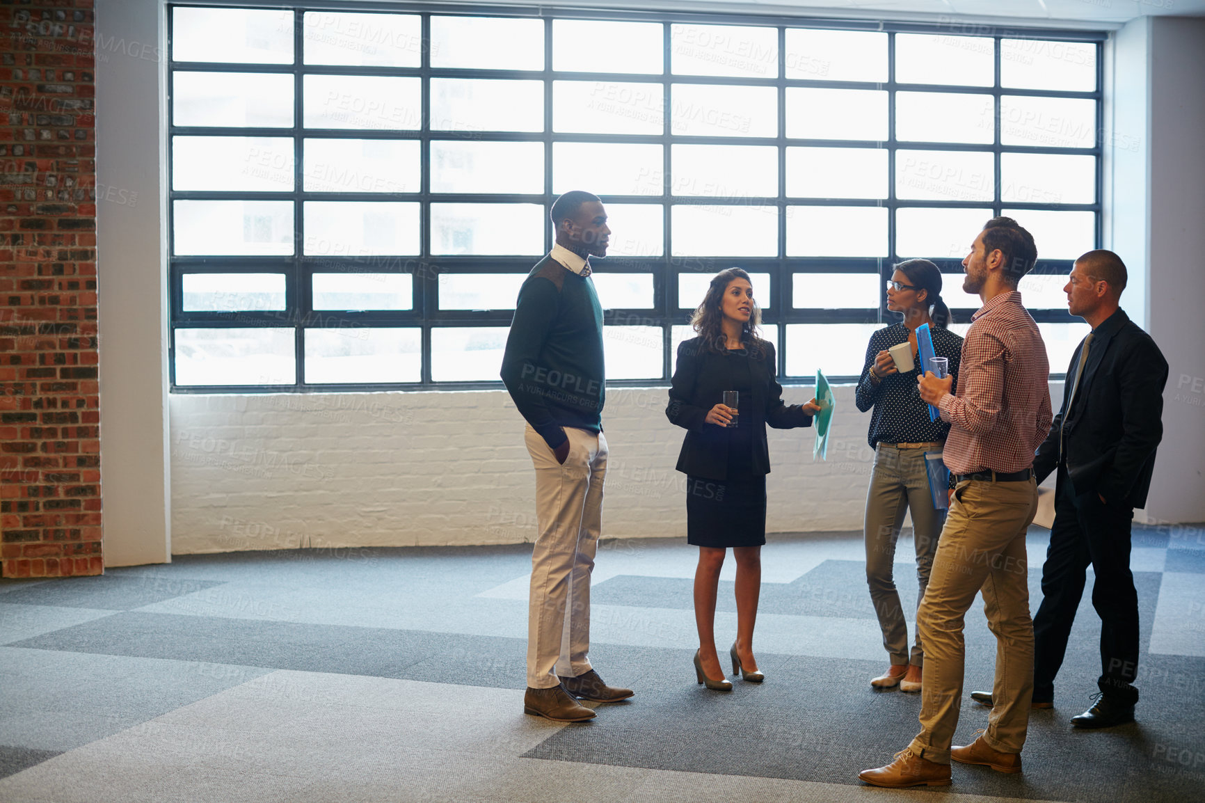 Buy stock photo Shot of a group of businesspeople having a discussion in an office