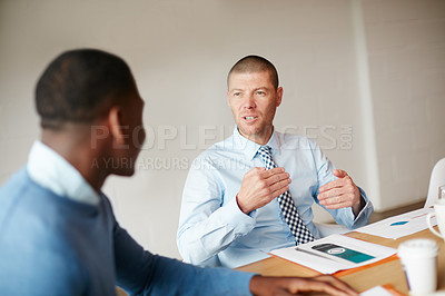 Buy stock photo Cropped shot of two businessmen working in the office