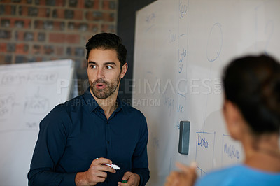 Buy stock photo Cropped shot of two businesspeople giving a presentation in the boardroom