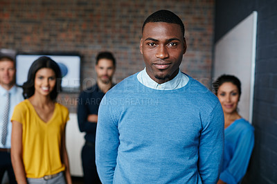 Buy stock photo Cropped portrait of a businessman standing in the workplace with his colleagues in the background