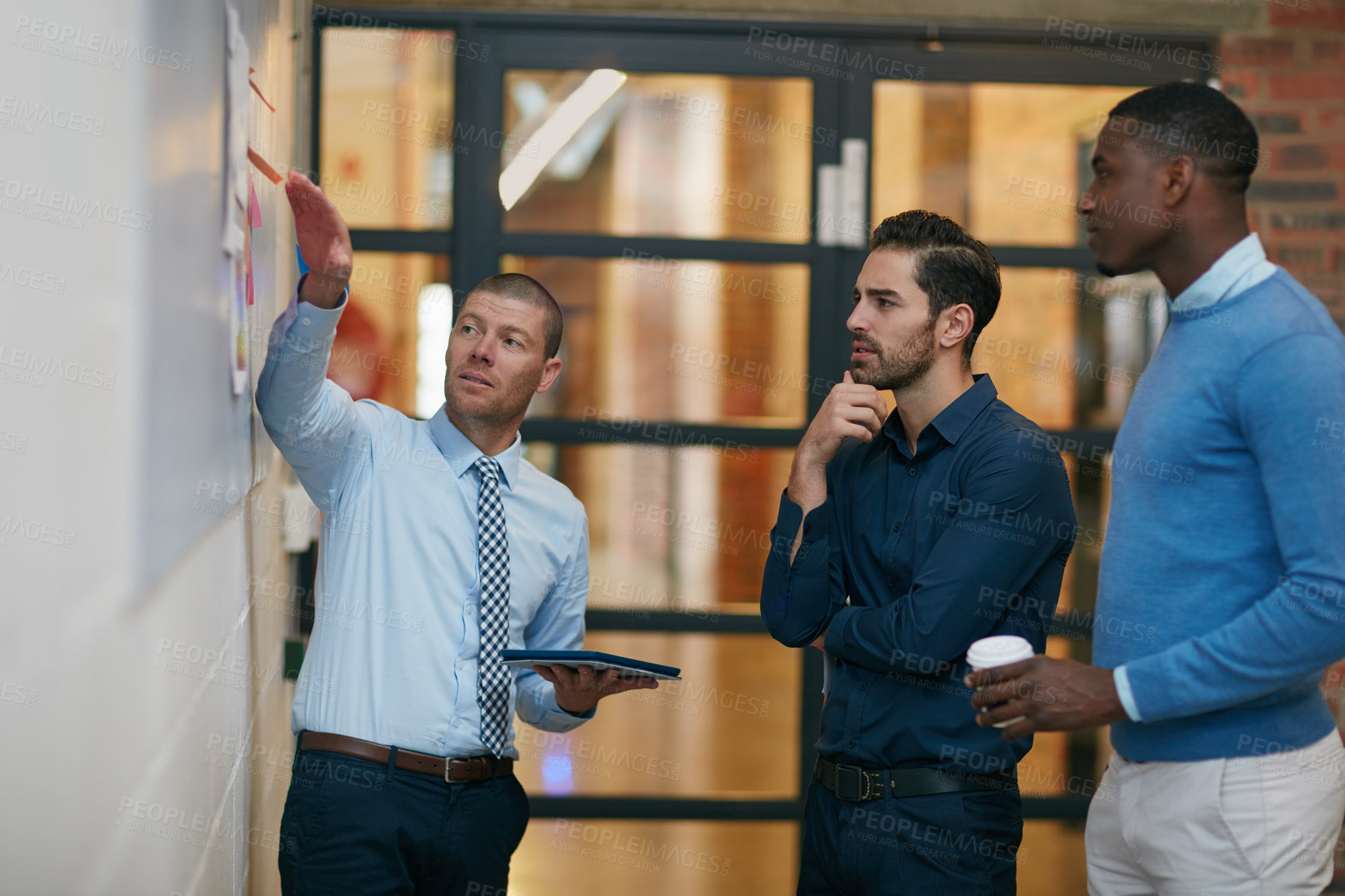 Buy stock photo Cropped shot of three businessmen in the office