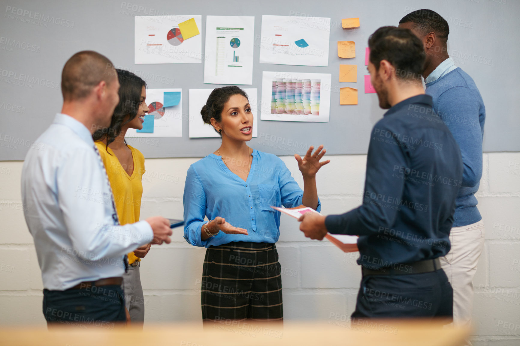 Buy stock photo Cropped shot of a group of businesspeople talking in the office