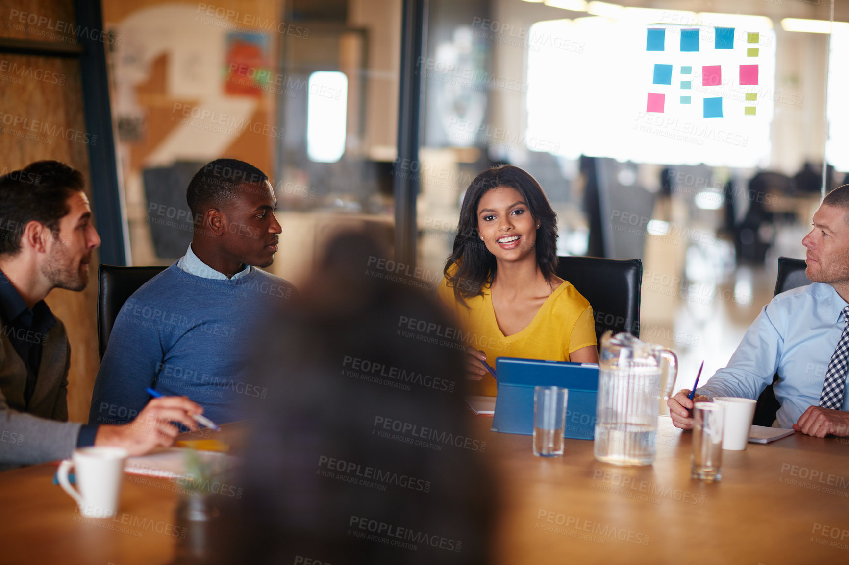 Buy stock photo Cropped shot of a group of businesspeople meeting in the boardroom