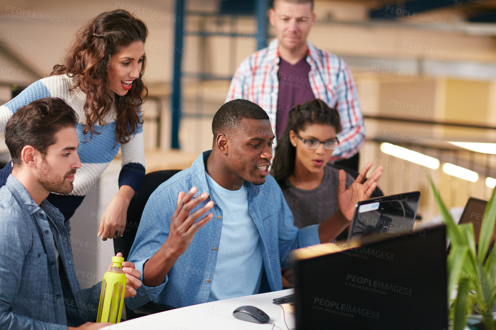 Buy stock photo Shot of team of colleagues using a computer together in a modern office