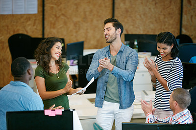 Buy stock photo Shot of a team of colleagues having an informal meeting in a modern office