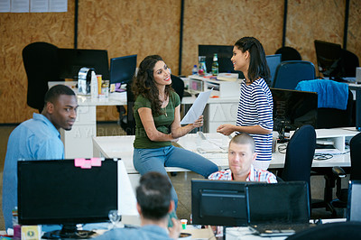 Buy stock photo Shot of a team of colleagues having an informal meeting in a modern office