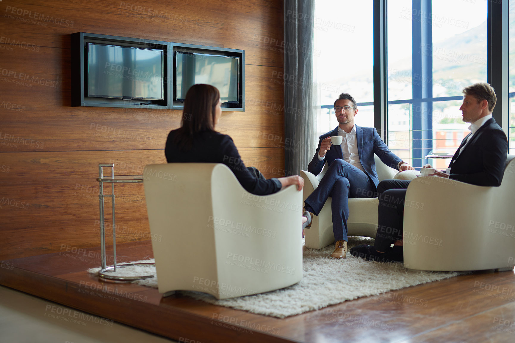 Buy stock photo Shot of three businesspeople talking in a corporate office