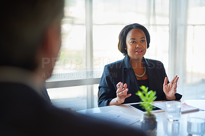 Buy stock photo Shot of two corporate businesspeople working in the boardroom