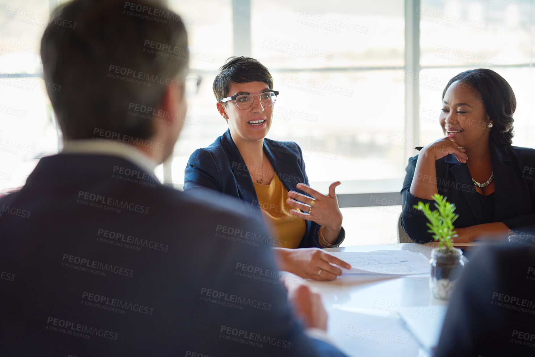 Buy stock photo Shot of four corporate businesspeople working in the boardroom