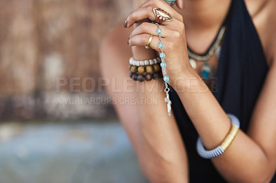 Buy stock photo Shot of a young woman praying with her rosary outdoors