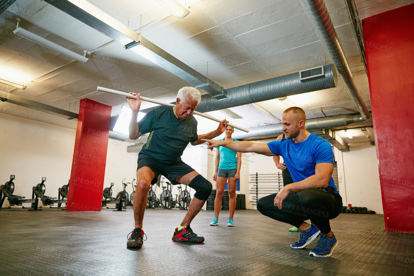 Buy stock photo Shot of a senior man doing pvc pipe exercises with the assistance of his trainer