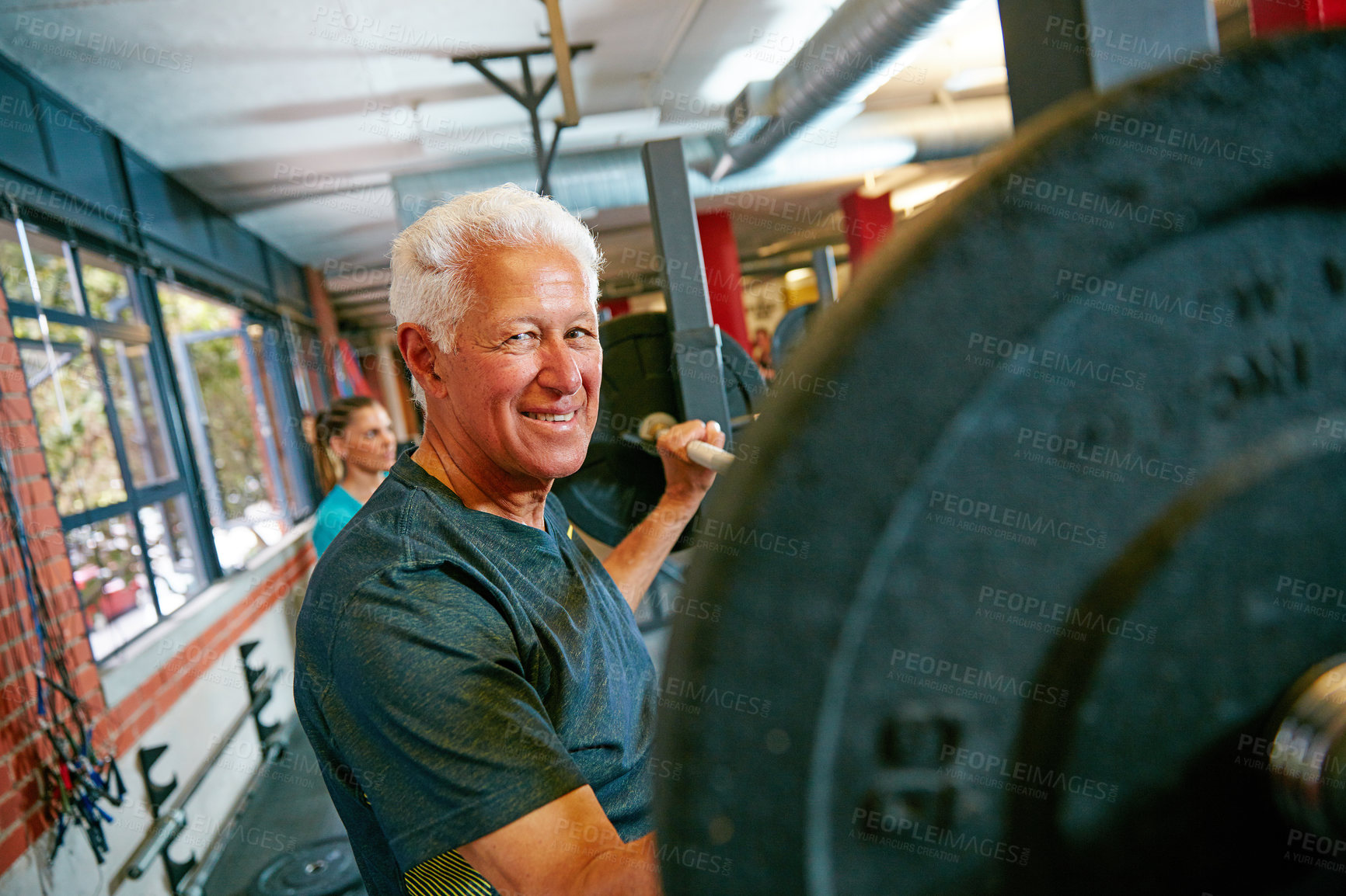 Buy stock photo shot of a senior man lifting weights at the gym