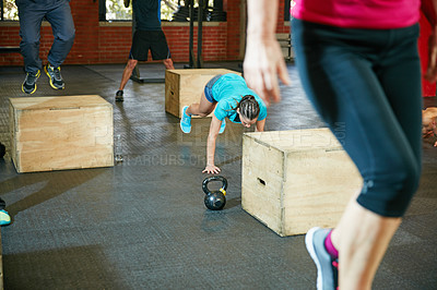 Buy stock photo Shot of a young woman doing push ups during her workout at the gym