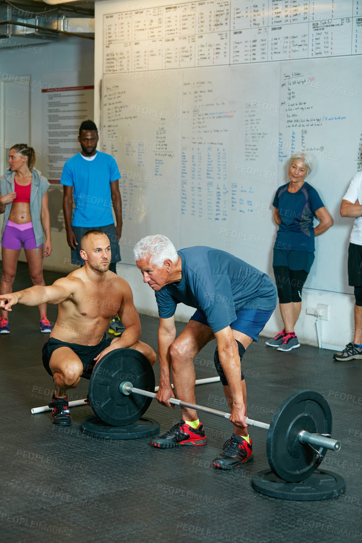 Buy stock photo Shot of a senior man working out with his fitness coach