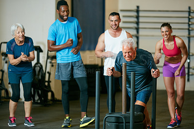 Buy stock photo Full length shot of a group of people cheering on a senior man in the gym