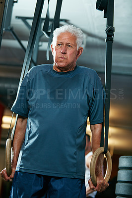 Buy stock photo Cropped shot of a senior man working out in the gym