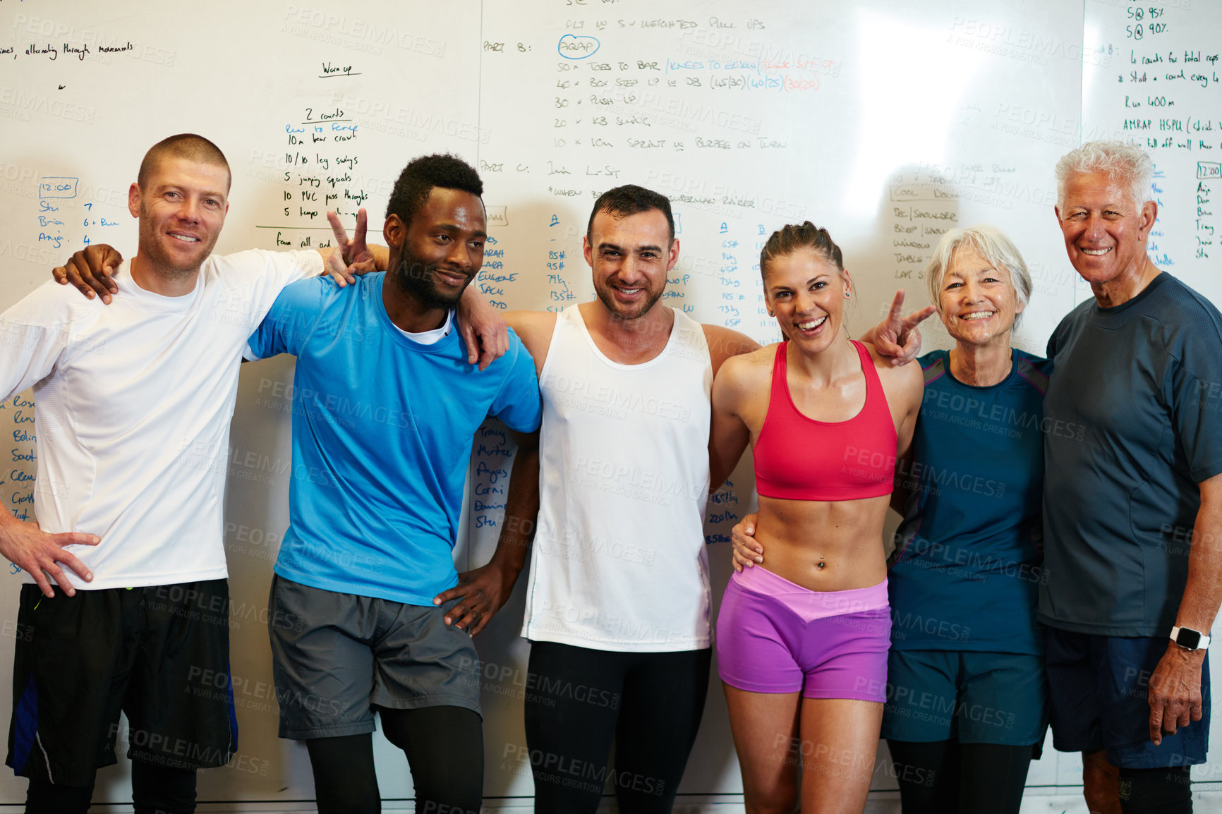 Buy stock photo Cropped portrait of a group of people standing with their arms around one another in the gym