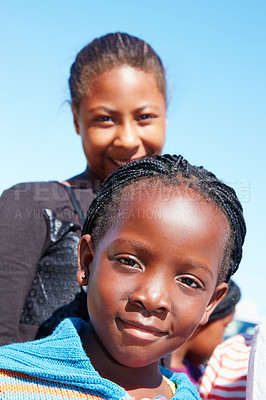 Buy stock photo Cropped portrait of two young children at a community outreach event
