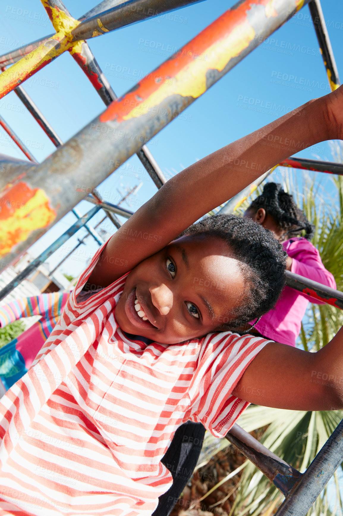 Buy stock photo Portrait of a happy little girl hanging on a jungle gym