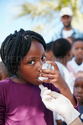 Buy stock photo Shot of a volunteer doctor giving checkups to underprivileged kids