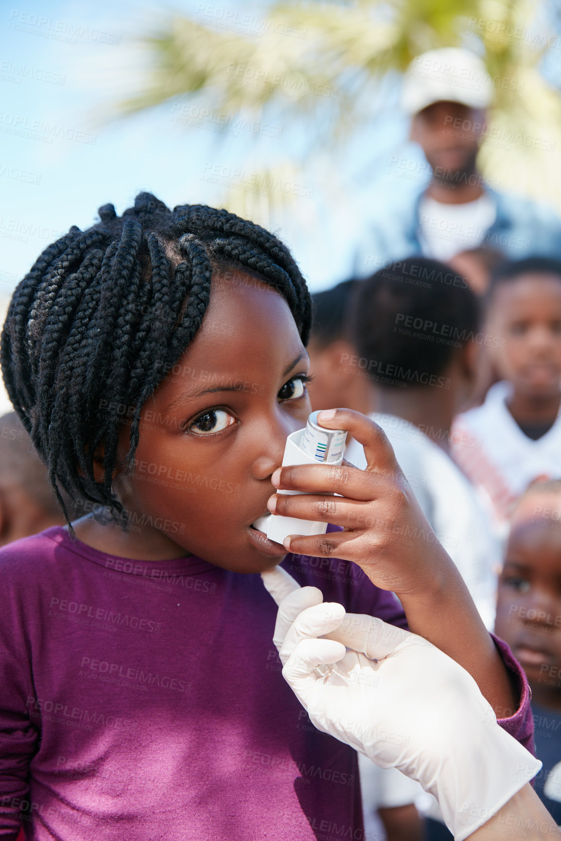 Buy stock photo Shot of a volunteer doctor giving checkups to underprivileged kids