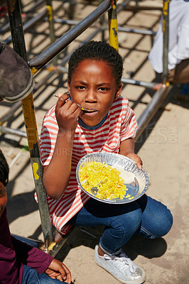 Buy stock photo Full length portrait of a young girl getting fed at a food outreach