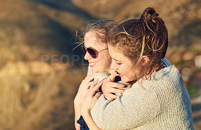 Buy stock photo Cropped shot of a teenage girl embracing her best friend outdoors