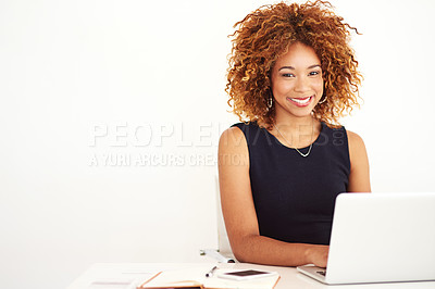 Buy stock photo Portrait of a young businesswoman working on a laptop at her desk