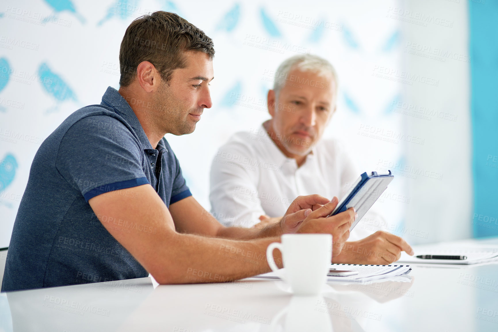 Buy stock photo Cropped shot of two men working in the office