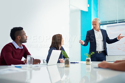 Buy stock photo Cropped shot of a mature businessman giving a presentation in the boardroom