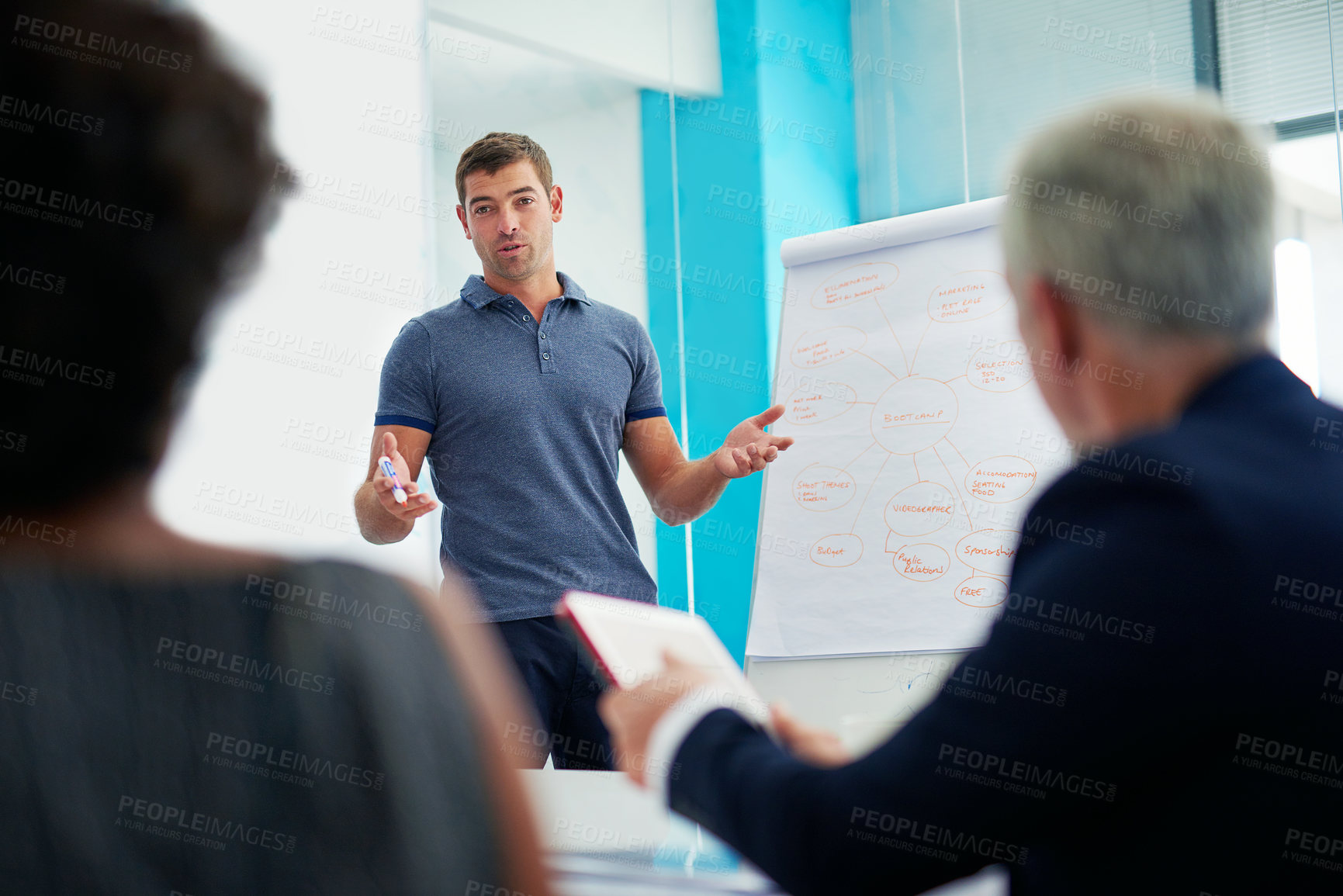 Buy stock photo Cropped shot of a young businessman giving a presentation in the boardroom