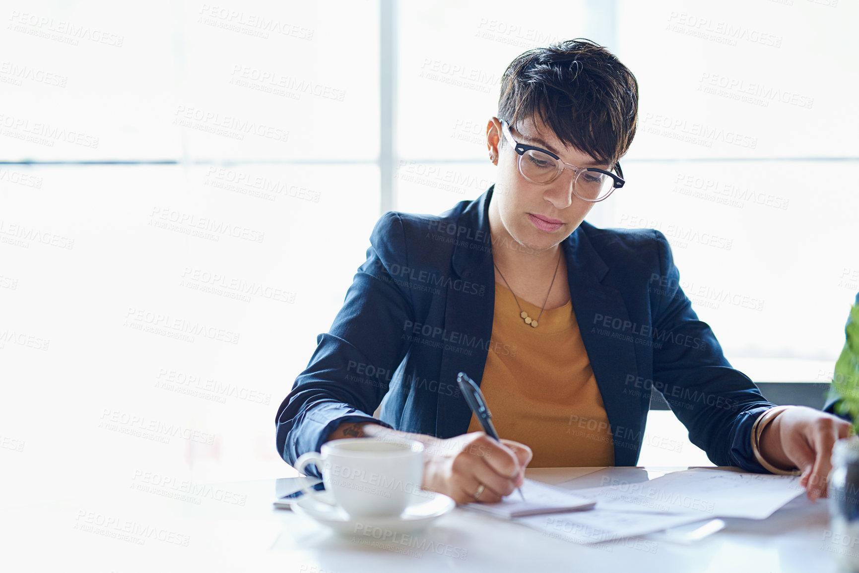 Buy stock photo Shot of a businesswoman working on paperwork in her office