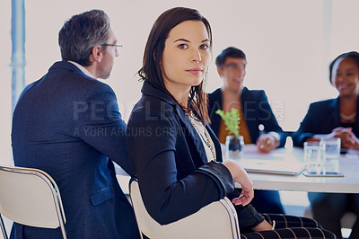 Buy stock photo Cropped portrait of a businesswoman sitting in the boardroom with her colleagues