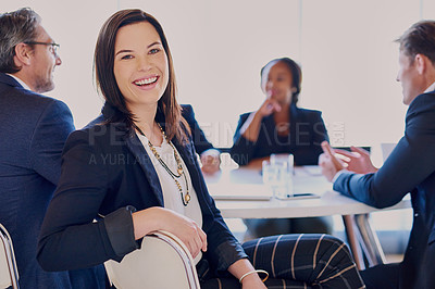 Buy stock photo Cropped portrait of a businesswoman sitting in the boardroom with her colleagues