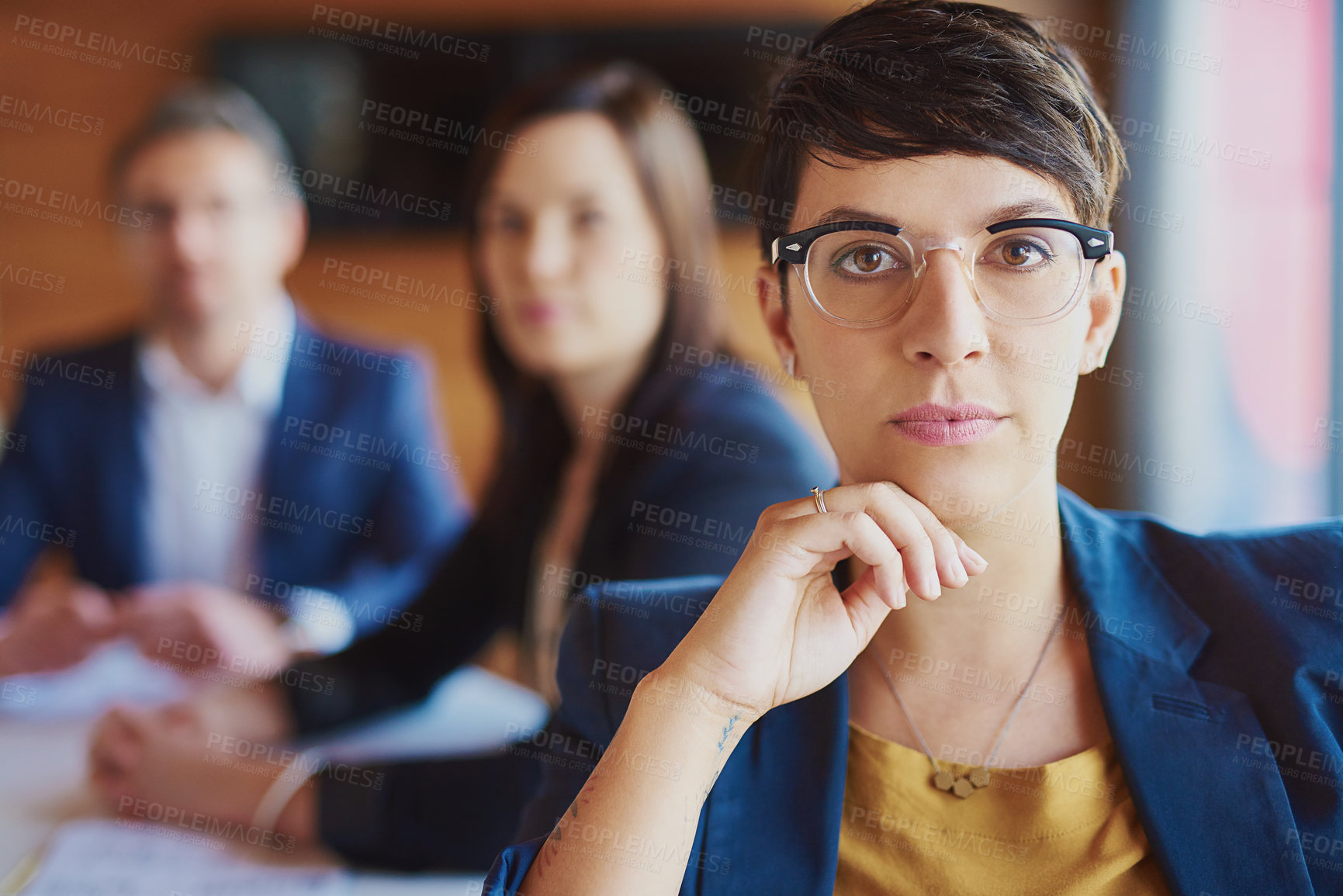 Buy stock photo Cropped portrait of a businesswoman sitting in the boardroom with her colleagues