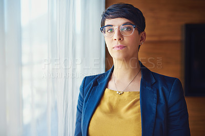 Buy stock photo Portrait of a confident businesswoman standing in her office