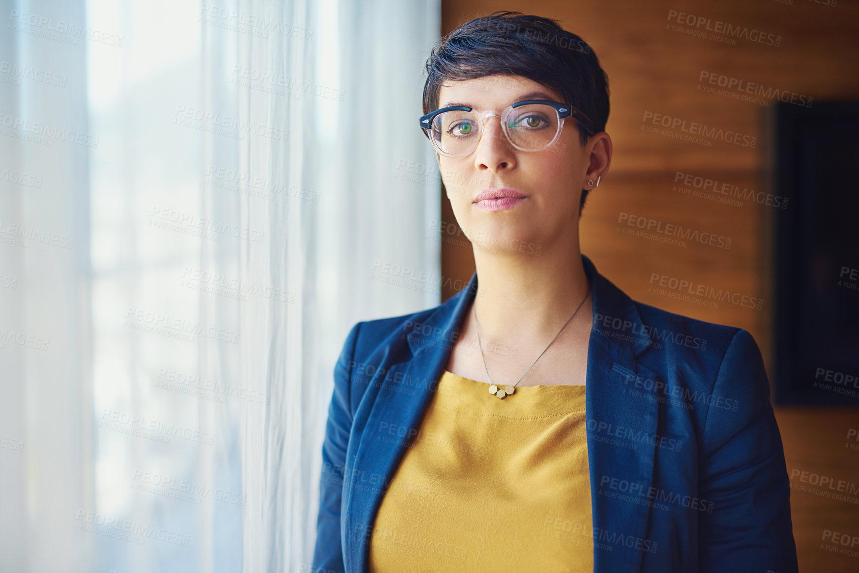 Buy stock photo Portrait of a confident businesswoman standing in her office