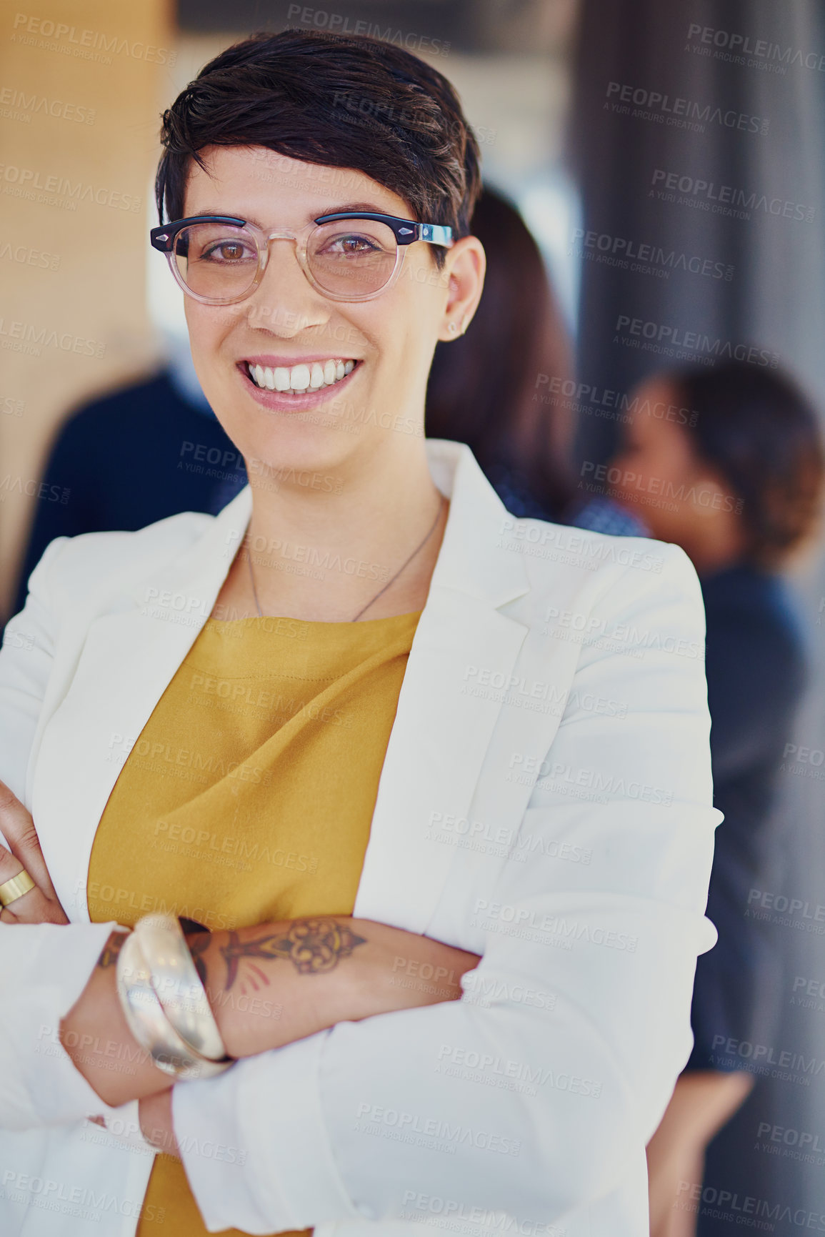 Buy stock photo Cropped portrait of a businesswoman standing in the office with her colleagues in the background